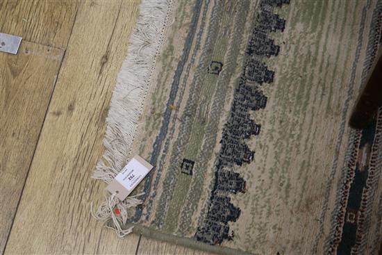 A Marks and Spencers Eastern rug, the centre field with lozenge devices